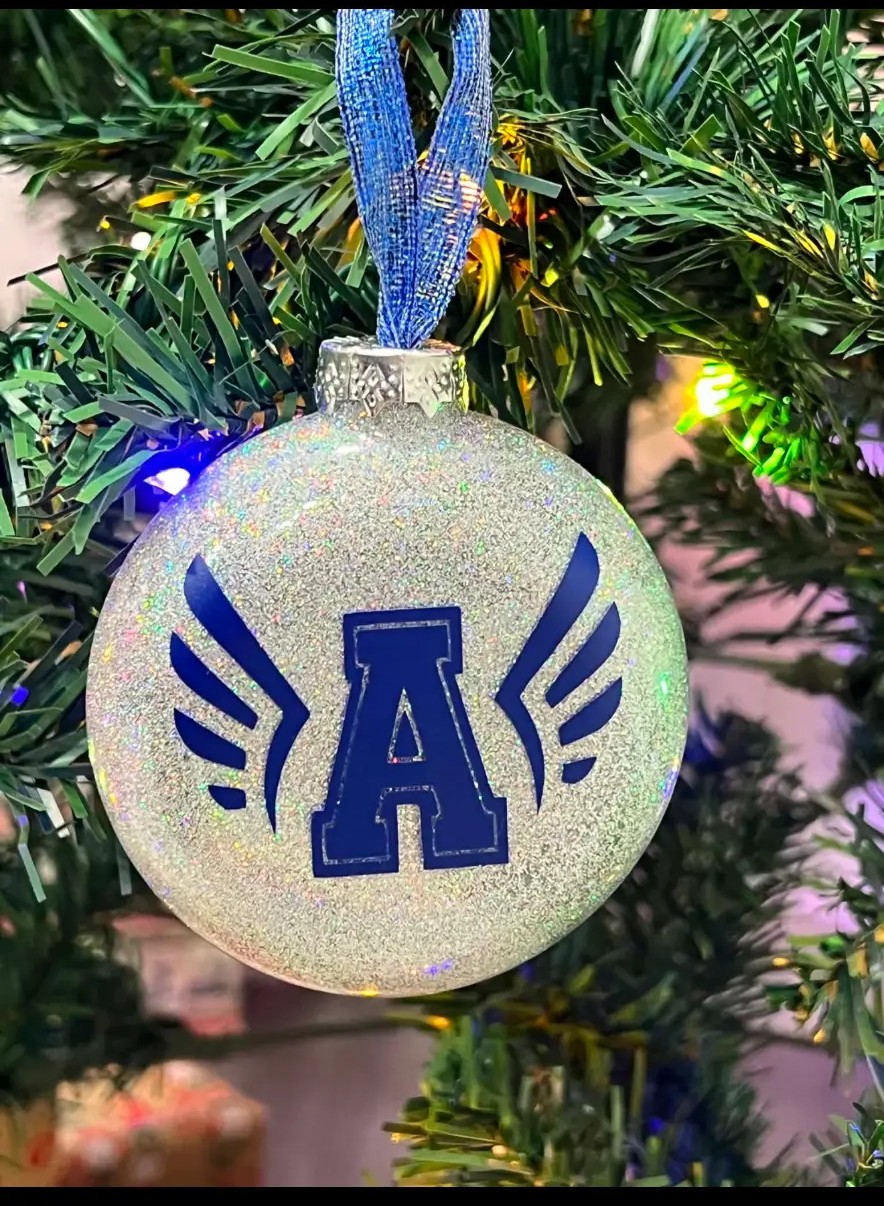 Silver glitter ornament with a blue winged letter A